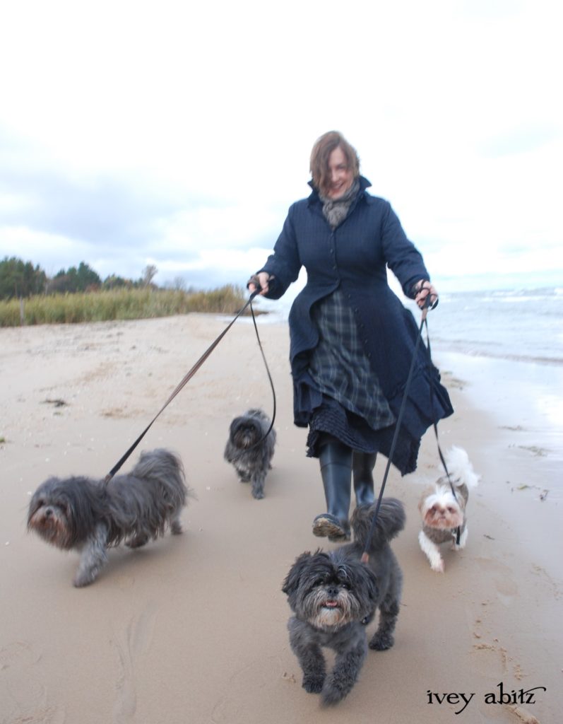 Cynthia Ivey Abitz, clothing designer, walks the beach with part of her shih tzu pack.
